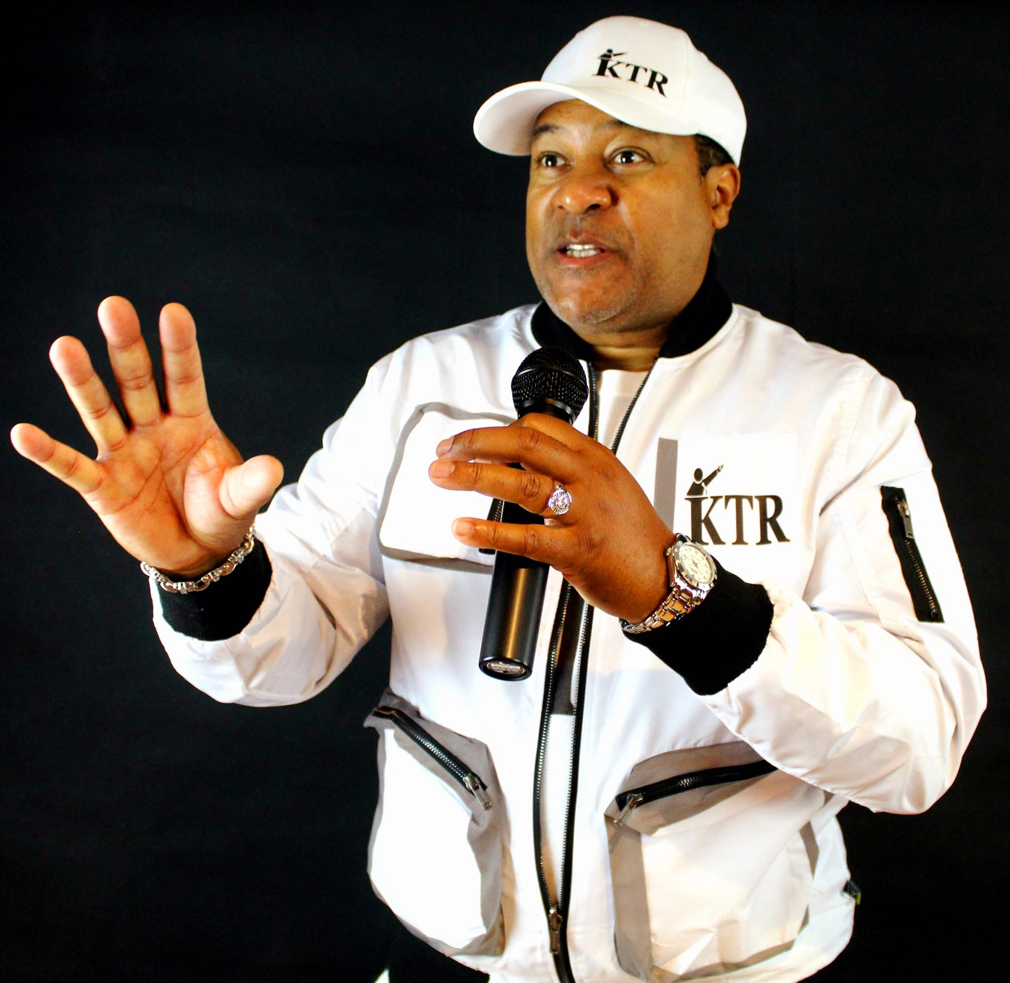 Kevin T. Robertson speaking in white KTR jacket